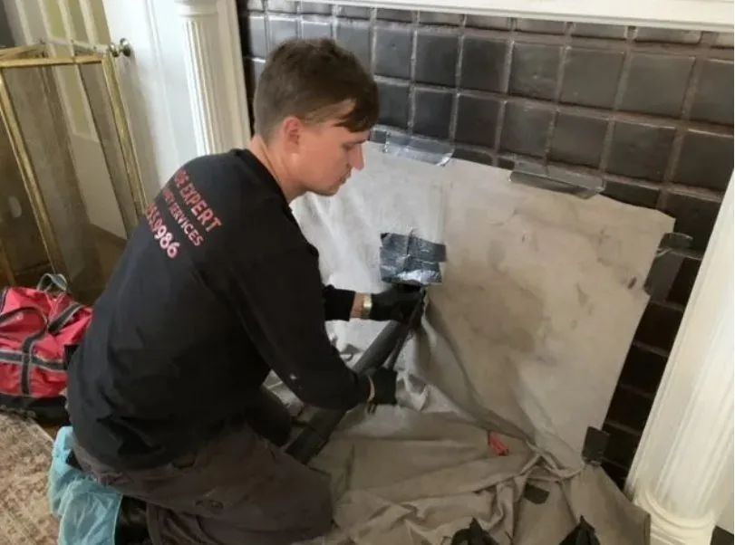 Jade Chimney technician performing fireplace service